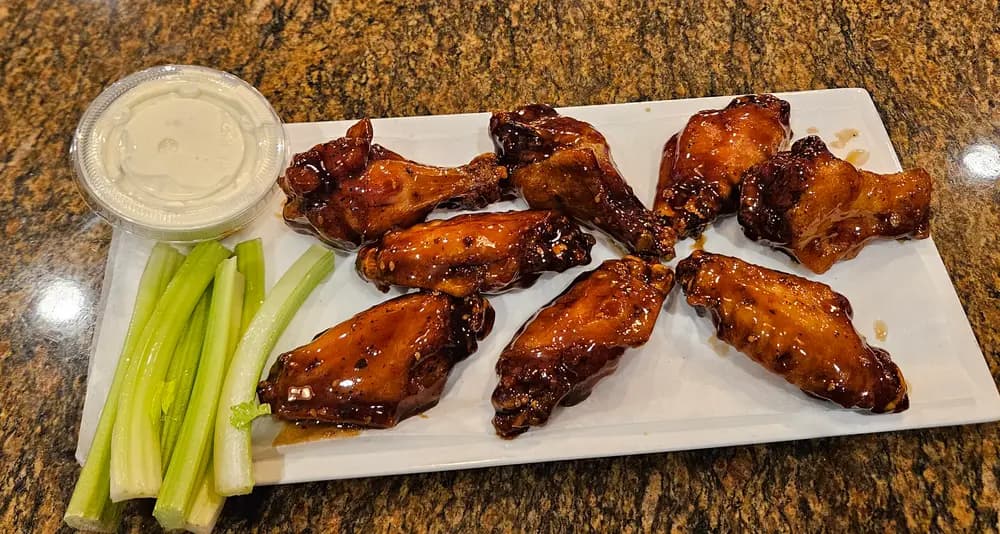 BBQ chicken wings with celery and blue cheese