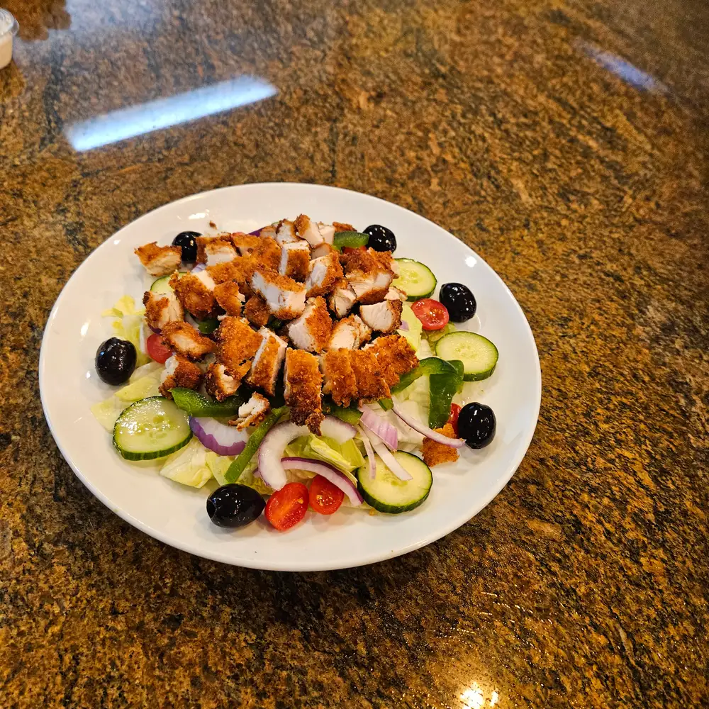 Crispy chicken salad with cucumbers, olives, tomatoes and red onion