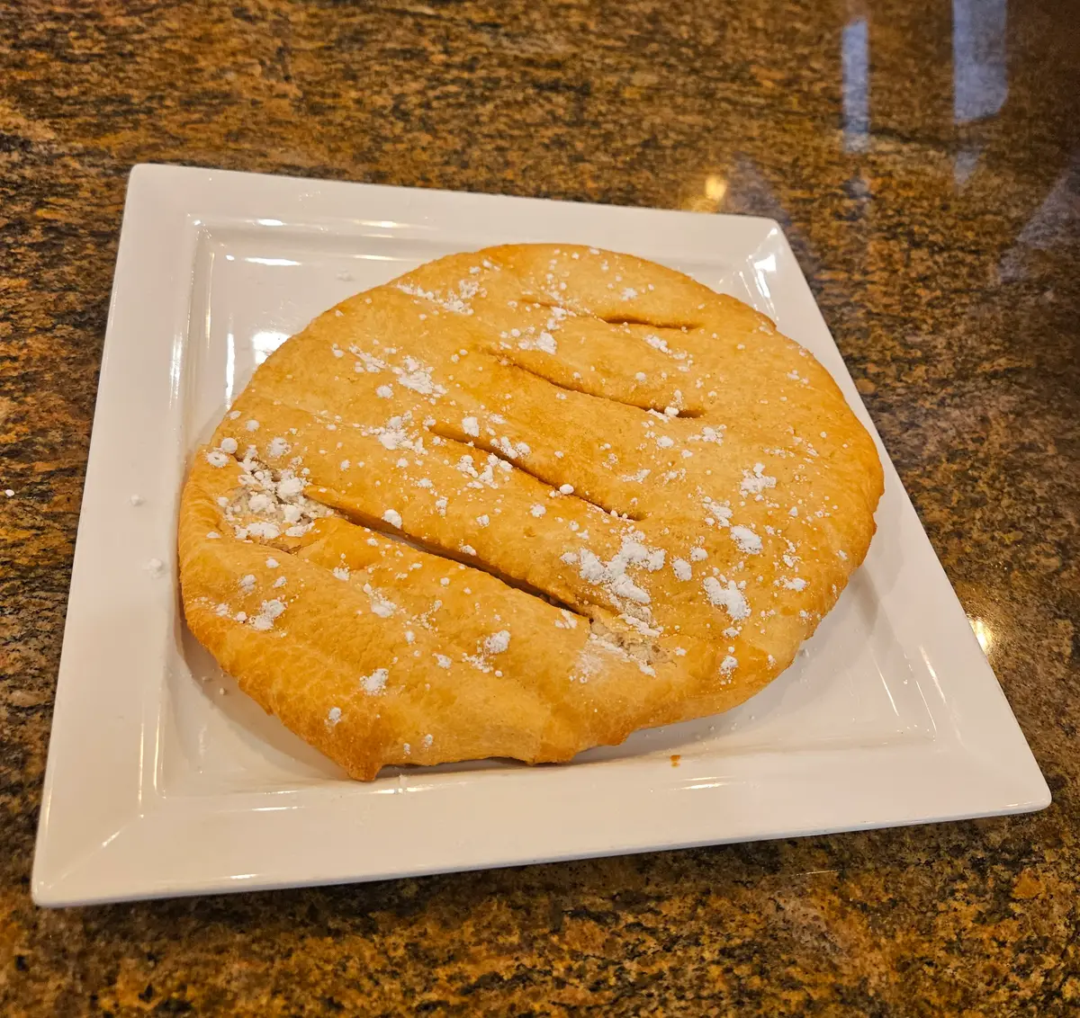 Fried dough with powdered sugar